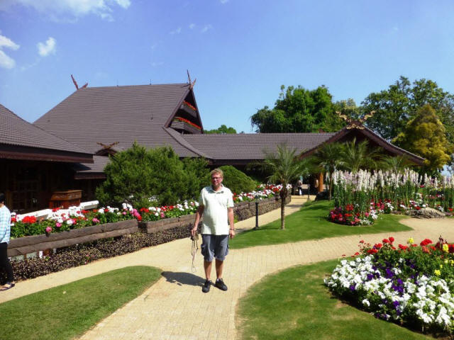 Chiang Rai Stefan in park flowers in front of houses