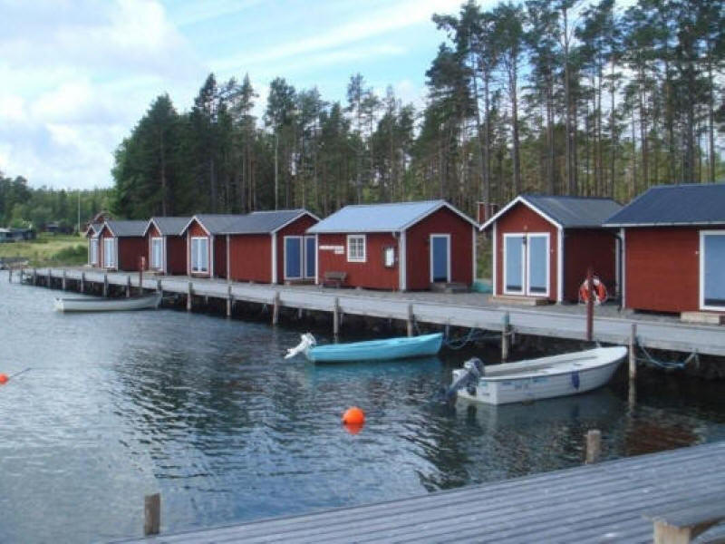 Morängsviken haven with small red swedish huts and blue boat